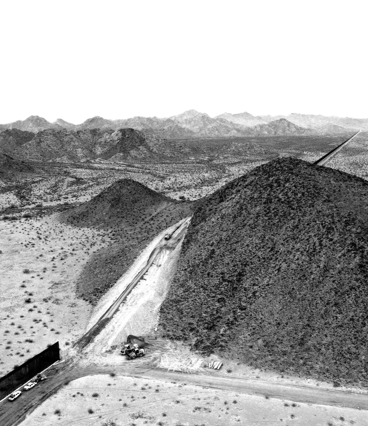 Black and white aerial image of the border wall in Arizona. 