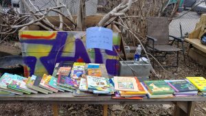 A spread of books with a sign that says "Free Boks"